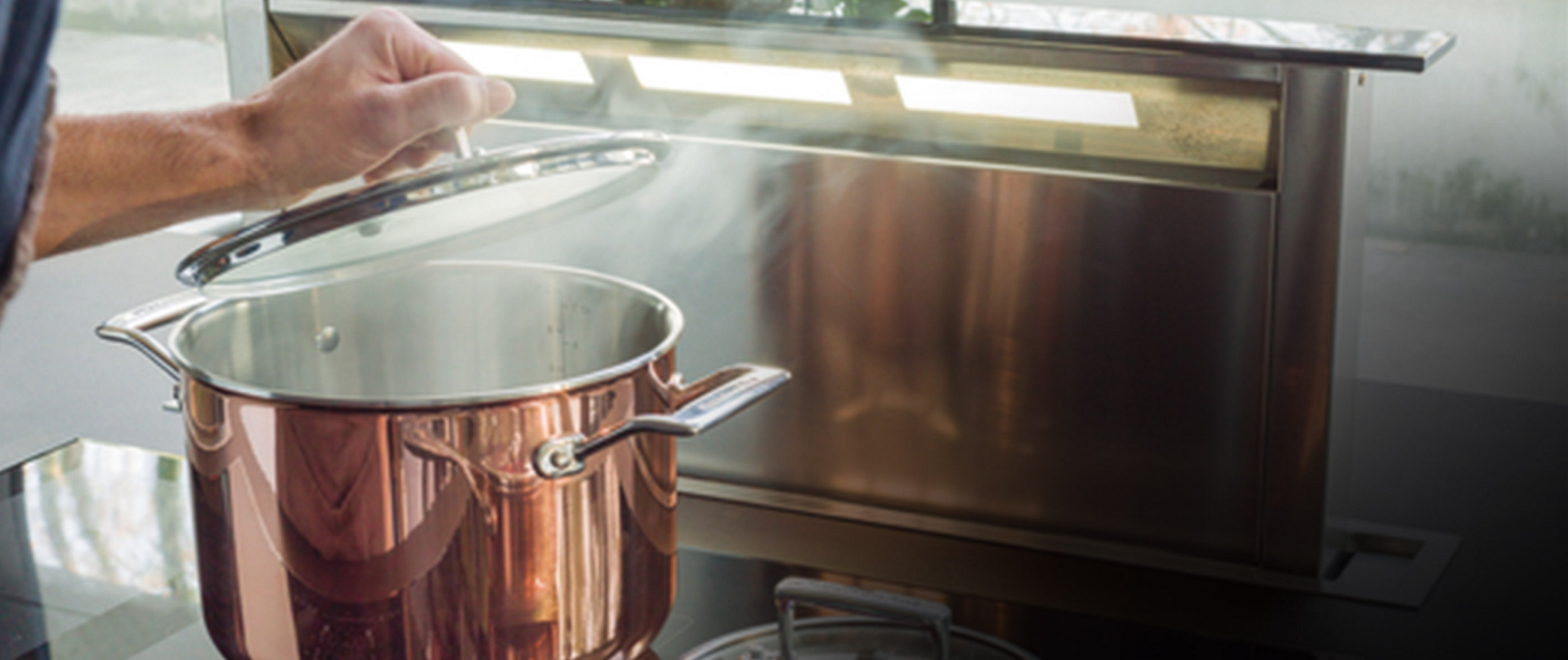 A KitchenAid food processor, loaded with a variety of colorful vegetables. All around it are the signs of preparation, with cut and uncut ingredients in various states of preparation.